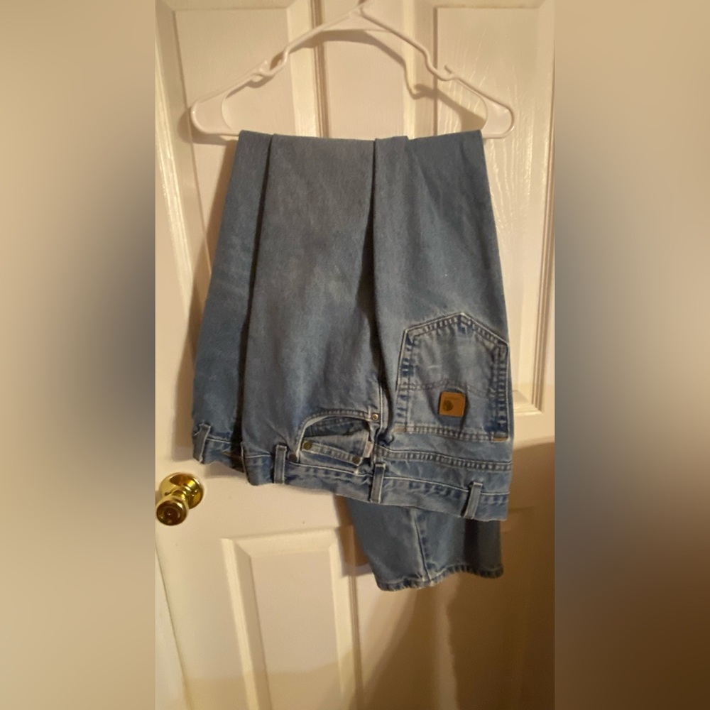 Mens Carhart 44x34 blue jeans.  Straight leg relaxed fit. One tear in the hem